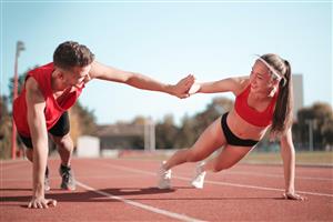 Man and woman exercising together on track